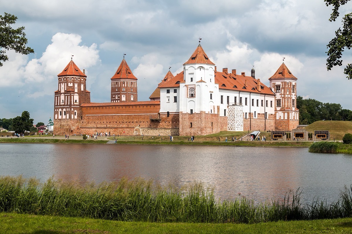 Mir Castle's red-brick towers seen across the lake